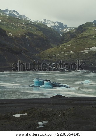 Frozen lake with glacier landscape photo. Beautiful nature scenery photography with mountains on background. Idyllic scene. High quality picture for wallpaper, travel blog, magazine, article