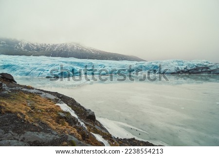 Frozen lake and glaciers landscape photo. Beautiful nature scenery photography with mountains on background. Idyllic scene. High quality picture for wallpaper, travel blog, magazine, article