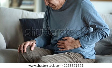 Senior man with stomach pain Royalty-Free Stock Photo #2238579371