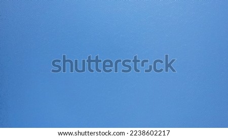 Top view of the blue surface of the lake water. A small ripple from the waves and a slight gradient from light blue to dark blue. Photo as a background. Clean water. Kolsai Lake, Kazakhstan