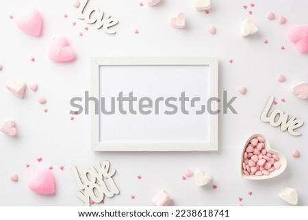 Valentine's Day concept. Top view photo of photo frame inscriptions love heart shaped saucer with sprinkles marshmallow and pink candles on isolated white background with blank space