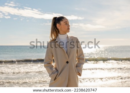 Portrait of a young pretty girl on the background of the sea