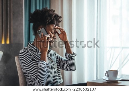 Outraged attractive employee talking on the phone, arguing with a client or customer, actively gesturing, a business woman who is seriously talking on a smartphone, solving a business problem Royalty-Free Stock Photo #2238632107