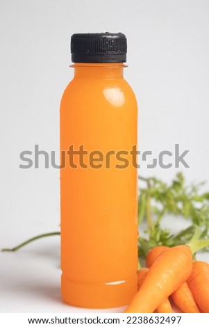 Carrot juice in a clear plastic bottle. Healthy drink.