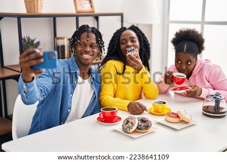 African american friends having breakfast and make selfie by the smartphone at home