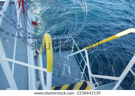 View of the vessel hardening on board ships using razor wire to stop pirates from boarding the ship. These ship protection measures are employed when the ship passes through high-risk areas