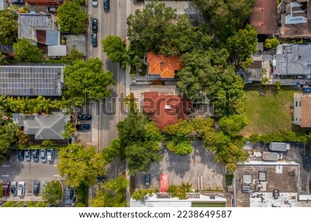 Aerial shot of Upper East Side residential neighborhood
in Miami, lush vegetation is seen, modern buildings, luxury houses, urban skyline, blue sky, street with cars Royalty-Free Stock Photo #2238649587