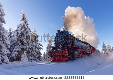 Harz narrow-gauge railway in a wintry landscape on the way to the Brocken Royalty-Free Stock Photo #2238688515