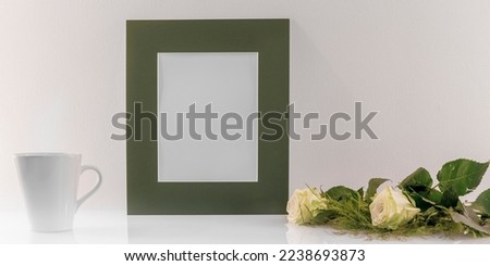 Model of photo frame with empty space for logos, advertising inscription. Frame in portrait mode on a work space.
