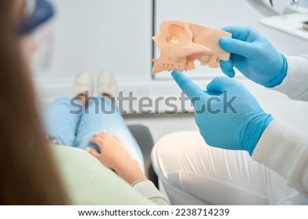 Dentist telling about jawbone loss to patient Royalty-Free Stock Photo #2238714239