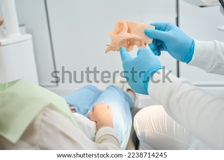 Stomatologist is telling about upper jawbone density to client Royalty-Free Stock Photo #2238714245