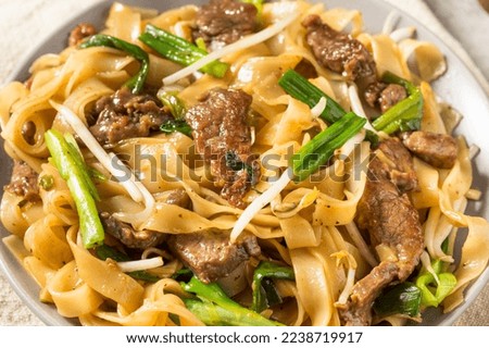Homemade Beef Chow Fun Asian Noodles with Scallions Royalty-Free Stock Photo #2238719917