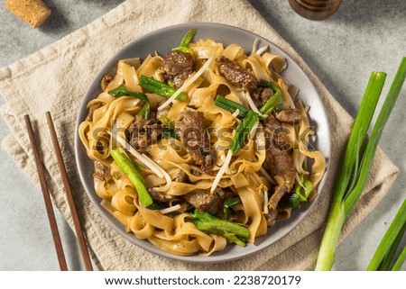 Homemade Beef Chow Fun Asian Noodles with Scallions Royalty-Free Stock Photo #2238720179