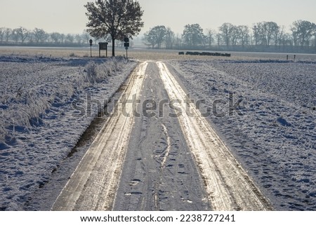 Icy road with tracks in winter season