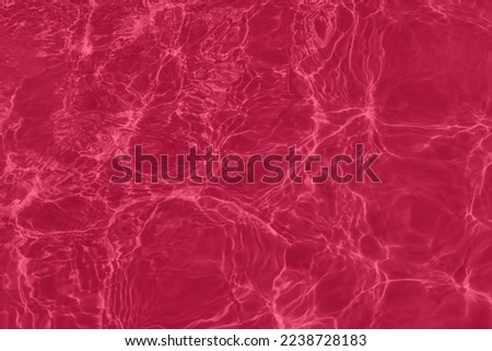 Transparent magenta water surface texture with ripples, splashes and bubbles. Abstract nature background Water waves in sunlight with copy space, 2023 color