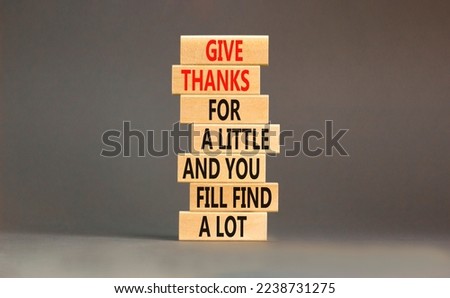Give thanks symbol. Concept words Give thanks for a little and you will find a lot on wooden blocks. Beautiful grey background copy space. Business motivational give thanks concept