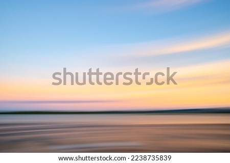 Motion blur abstract background image. Beach-side impressionism painterly effect photography at dawn or dusk.