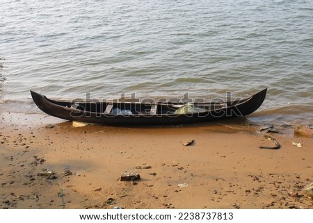 Small wooden fish boat on shore, sea background