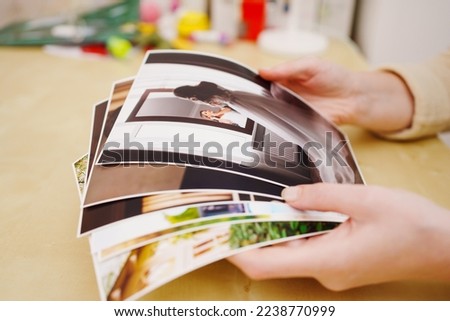 printed wedding photos in the printed wedding photos in the women hands. the concept of preserving the memory of an important event, the services of a professional photographer for the celebration.