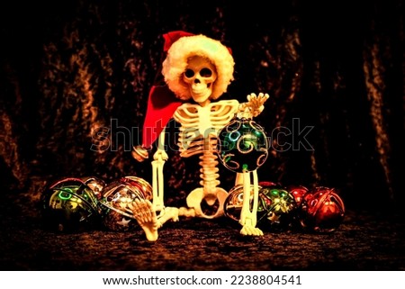 Facing forward this skeleton holding a Xmas Ball while sorting ornaments