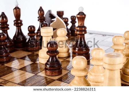 Beige Brown Wooden chess different pieces figures standing on chessboard. Close up game concept competition, Classic Gambit Tournament of confrontation.