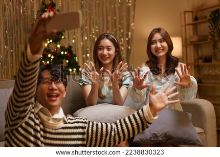 New Year celebration concept, Group of friend takes selfie on smartphone together in new year party.