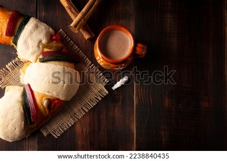 Traditional Kings day cake also called Rosca de Reyes, roscon, Epiphany Cake and with a clay Jarrito. Mexican tradition on January 5th Royalty-Free Stock Photo #2238840435