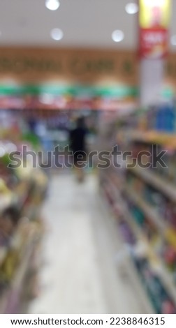 Blur people shoping in super store with bokeh light background.
