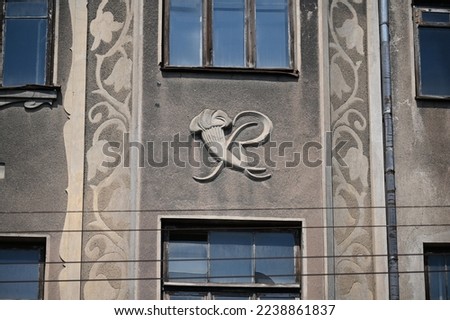 a fragment of a historical building with a decorative detail between the windows
