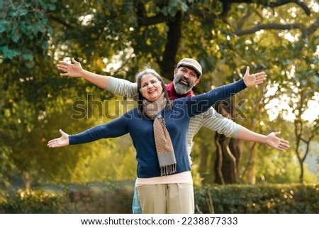 old couple in warm wear in winter at park Royalty-Free Stock Photo #2238877333