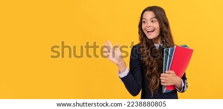 happy teen girl hold school copybook for homework studying on yellow background waving hello, school. Banner of school girl student. Schoolgirl pupil portrait with copy space.