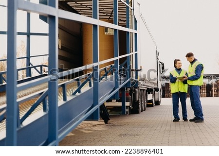 engineer man control loading containers box from cargo freight ship for import export. Logistic, transportation, import and export concept with copy space. High quality photo