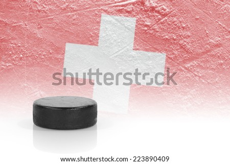 Hockey puck and the image of the Swiss flag. Concept