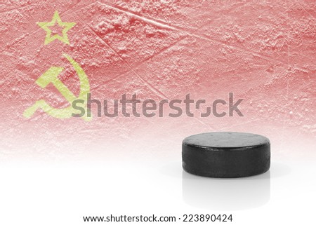 Hockey puck and the image of the Soviet flag. Concept