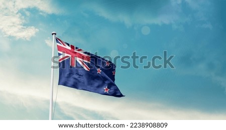 New Zealand national flag waving in beautiful sky.