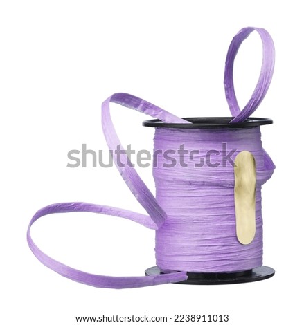 Bobbin with purple paper tape for gift wrapping isolated on white background