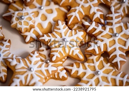 Christmas Cookies in Shape of Stars with Icing and Pearls. Snowflake Cookies for Santa Clause. Background of Cookies with Icing Royalty-Free Stock Photo #2238921795