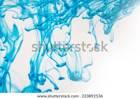 Blue liquid in water making abstract forms