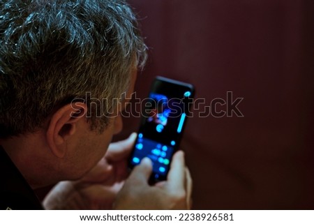 a middle aged man using smartphone