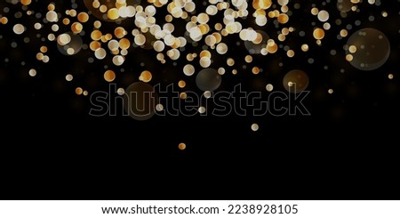 Festive golden luminous background with colorful lights bokeh. Christmas concept. Abstract glowing bokeh lights isolated on black background.