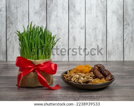 Festive table in honor of Navruz. Wheat with a red ribbon, the traditional holiday of the vernal equinox Nawruz