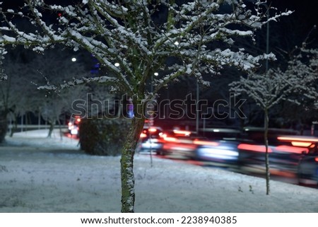 
WINTER IN THE CITY - Snowy and frosty winter evening and traffic jam on the city street