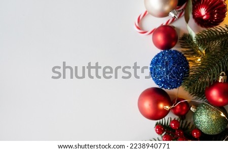 festive new year layout with place for text. christmas decorations,  fir branches on a white background. top view. flat lay. copy space. red,blue and green colors.
