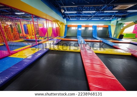 Set of trampolines at indoor play center playground.  Royalty-Free Stock Photo #2238968131