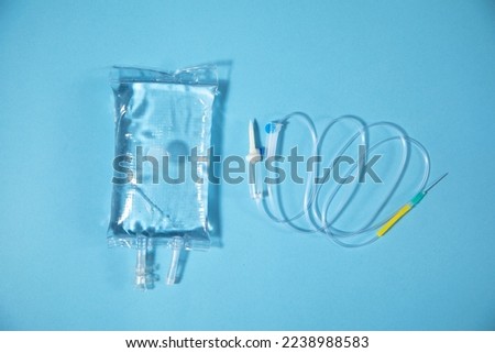  Infusion bag in the blue background. IV drip chamber Royalty-Free Stock Photo #2238988583