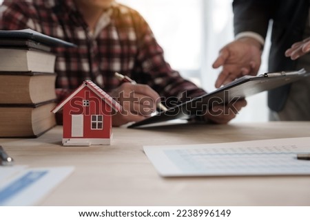 Sign a contract, Credit approver, businessman in male suit and house toy model mockup Home loan mortgage approval concept. After signing the contract
