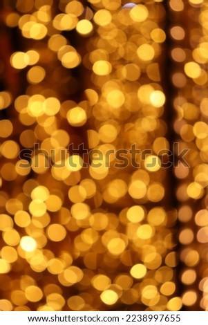 Golden Christmas lights defocused in bokeh effect. Can be used as wallpaper. Can be used for New year’s celebration. Copy space.