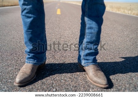 Cowboy boots on a road 
