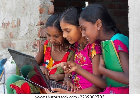 School Students Girls using laptop while studying at home Royalty-Free Stock Photo #2239009703