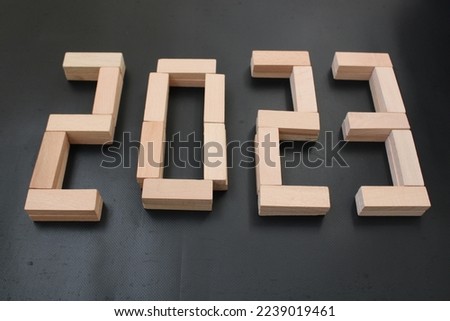The number 2023 written in wooden blocks. Beginning and start of the new year 2023. Preparation for happy new year ,new life, new business, plan, goals, strategy concept. 